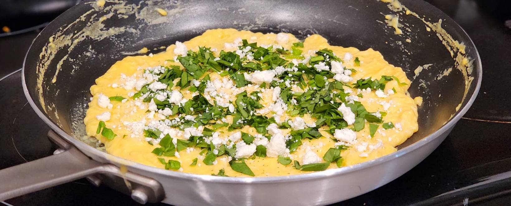 https://themamasaur.com/wp-content/uploads/2023/11/spinach-and-feta-sprinkled-on-French-omelette.jpg